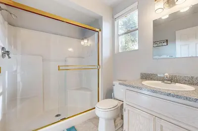 a bathroom with a shower and a toilet and a sink at Serendipity in Groveland