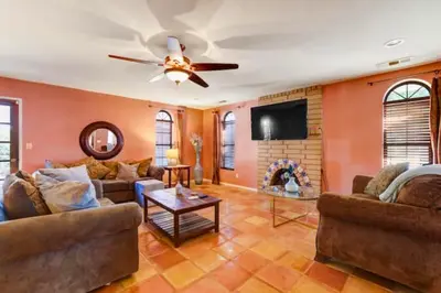 a living room with a couch and a ceiling fan at Happy Hours - Beautiful Quiet Comfortable Suite #3 in Visalia