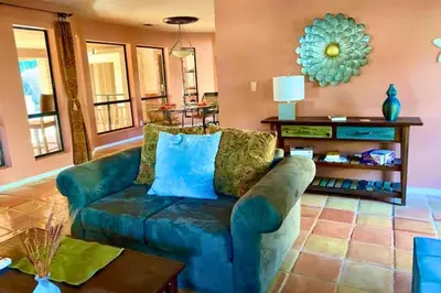 a living room with a blue couch and a table at Happy Hours - Beautiful Quiet Comfortable Suite #3 in Visalia
