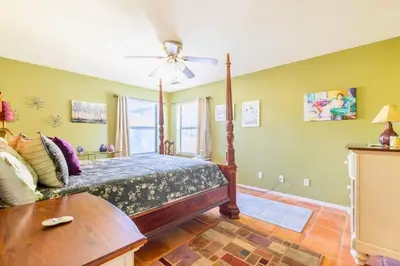 a bedroom with a bed and a ceiling fan at Happy Hours - Beautiful Quiet Comfortable Suite #3 in Visalia