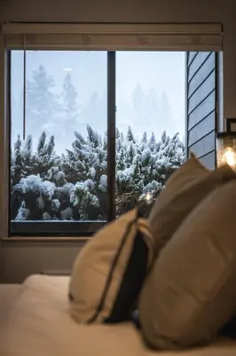 a bed with two pillows in front of a window at Lakeland Studio - Walk to Casinos, Restaurants And Gondola in South Lake Tahoe