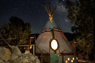 a yurt with a light in the middle at night at Big Glamping Teepee in Bodfish