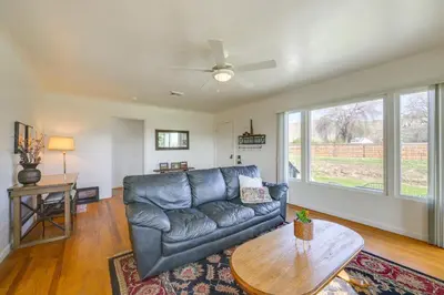 a living room with a leather couch and a table at 19 Mi to Sequoia Natl Park Mtn-View Woodlake Gem in Woodlake