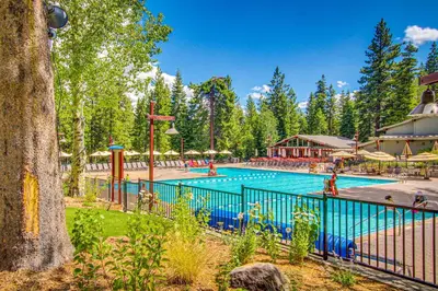 a pool at a resort with people playing in it at The Cozy Condo in Kingswood Estates