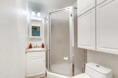 a white bathroom with a shower and a toilet at Drive to Major Parks Nature Getaway in West Point in West Point