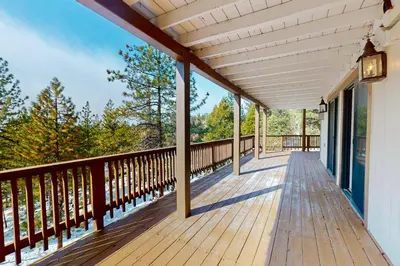 a wooden deck on a house with trees at Cliffside Retreat in Zephyr Cove