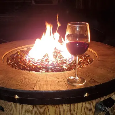a glass of wine sitting next to a fire pit at Casita Andrade in Turlock