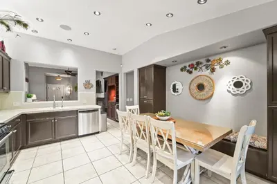 a kitchen and dining room with a wooden table and chairs at Casita Andrade in Turlock
