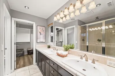 a bathroom with two sinks and a large mirror at Casita Andrade in Turlock