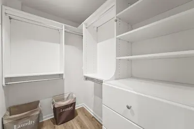 a walk in closet with white cabinets and a window at Casita Andrade in Turlock