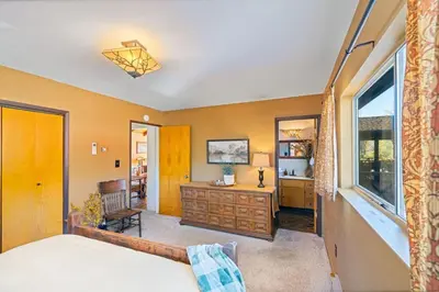a bedroom with a bed and a desk and a window at 10-acre Forest Villa, 20 miles from Yosemite South in Oakhurst