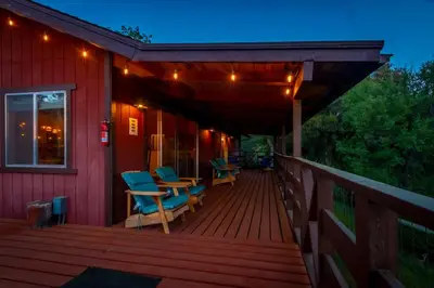 a deck with chairs and a table on a house at 10-acre Forest Villa, Single Floor, Hot tub, Patio in Oakhurst