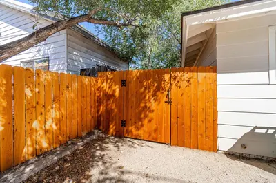 a wooden fence in front of a house at Emerald Escape - UNR & Pet Friendly in Reno
