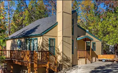 a large house with a porch and a tower at SunRidge at Willow Cove Free Night Special in Bass Lake