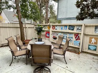 a patio with a table and chairs and a fence at Artist's Condo with 2 Bedroom & Arcade in Sacramento