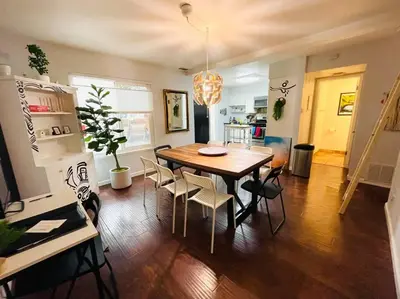 a dining room with a wooden table and chairs at Artist's Condo with 2 Bedroom & Arcade in Sacramento