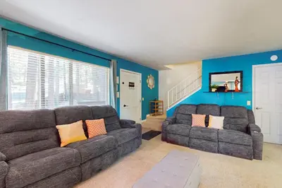 a living room with two couches and blue walls at Wildwood Wonder in South Lake Tahoe