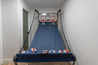 a gymnasium with a basketball court and a blue floor at Yosemite Lookout Lodge w/ hot tub, firepits, game room, and more in Oakhurst
