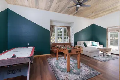 a living room with a ping pong table at Cedar Creek Lodge with POOL/hot tub/sleeps 24 in Oakhurst