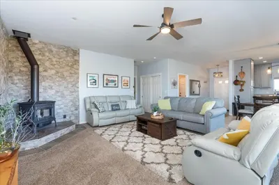a living room with a couch and a fireplace at Hilltop Paradise with stunning views/hot tub/firepit/dog friendly in Oakhurst