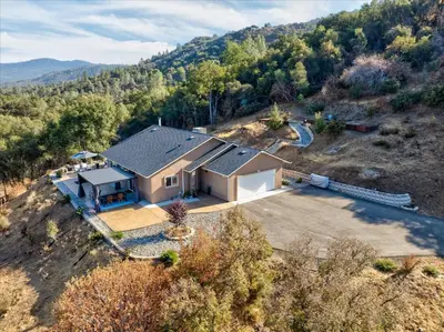 an aerial view of a house on a hill at Hilltop Paradise with stunning views/hot tub/firepit/dog friendly in Oakhurst