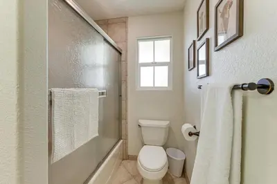 a bathroom with a toilet and a glass shower at Walk Downtown Remodeled Home in Murphys with Yard! in Murphys