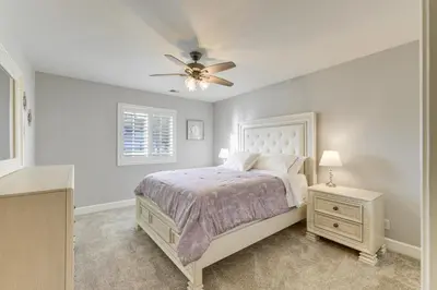 a bedroom with a bed and a ceiling fan at Walk Downtown Remodeled Home in Murphys with Yard! in Murphys