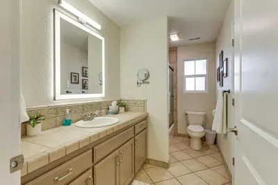 a bathroom with a sink and a toilet and a mirror at Walk Downtown Remodeled Home in Murphys with Yard! in Murphys