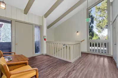 a living room with a table and some windows at Inside Yosemite Park-Cozy Corner Unit-Sleeps 2 in Yosemite West