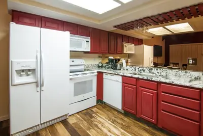 a kitchen with white appliances and red cabinets at North Lake Lodges & Villas in Incline Village