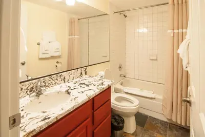 a bathroom with a sink and a toilet and a mirror at North Lake Lodges & Villas in Incline Village