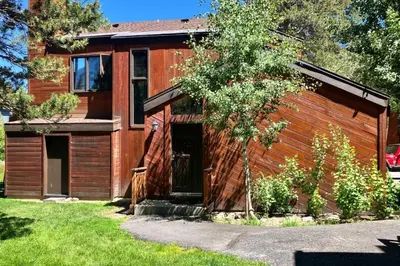 a wooden house with a door in a yard at Meadow Ridge 44 in Mammoth Lakes