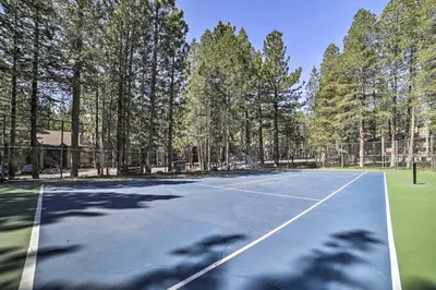 a tennis court with trees in the background at Sunshine Village #108- 1 +Loft , Sleeps 6. Steps from Free Town Shuttle ,Dog Friendly in Mammoth Lakes