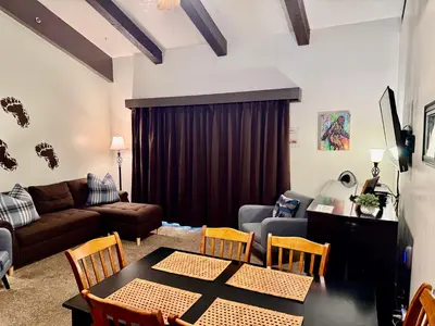 a living room with a couch and a table and chairs at Treetop Condo in Yosemite-Sleeps 6-Balcony in Yosemite West