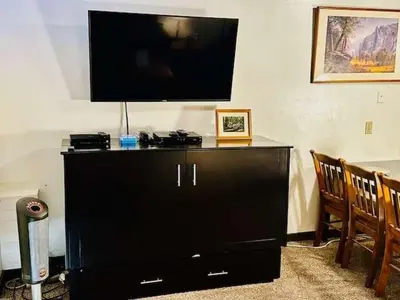 a black entertainment center with a flat screen tv on top at Treetop Condo in Yosemite-Sleeps 6-Balcony in Yosemite West