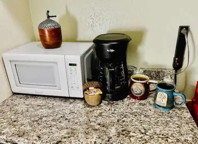 a microwave sitting on top of a counter with cups at Treetop Condo in Yosemite-Sleeps 6-Balcony in Yosemite West