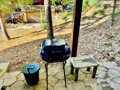 a grill and a bench next to a tree at Stay in Yosemite-Cozy Bear North-Sleeps 5 in Yosemite West