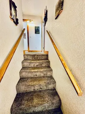 a staircase in a building with a stair case at Stay in Yosemite-Cozy Bear North-Sleeps 5 in Yosemite West