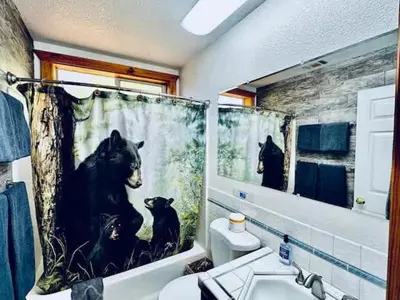 a bathroom with a black bear shower curtain at Stay in Yosemite-Cozy Bear North-Sleeps 5 in Yosemite West