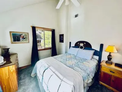 a bedroom with a bed and a lamp and a window at Stay in Yosemite-Cozy Bear North-Sleeps 5 in Yosemite West