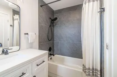 a bathroom with a shower and a sink and a tub at Cozy Family Haven in Sparks - Pet Friendly - Fenced Yard in Sparks