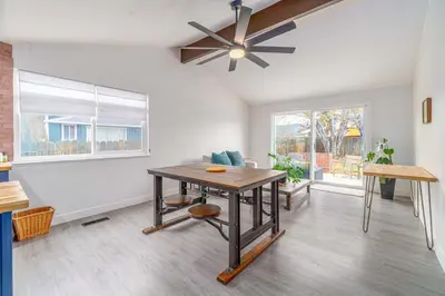 a living room with a table and a ceiling fan at Cozy Family Haven in Sparks - Pet Friendly - Fenced Yard in Sparks