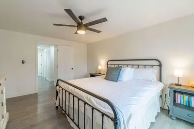 a bedroom with a bed with a ceiling fan at Cozy Family Haven in Sparks - Pet Friendly - Fenced Yard in Sparks