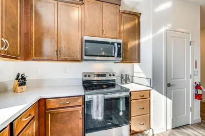 a kitchen with a stove and a microwave at 15 Mi to Dtwn Sacramento Newly Built Home! in Sacramento