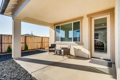 a patio with chairs and tables on a house at 15 Mi to Dtwn Sacramento Newly Built Home! in Sacramento