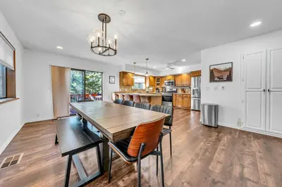 a dining room and kitchen with a wooden table and chairs at Tahoe Retreat with Decks and Separate Studio in Tahoe Vista