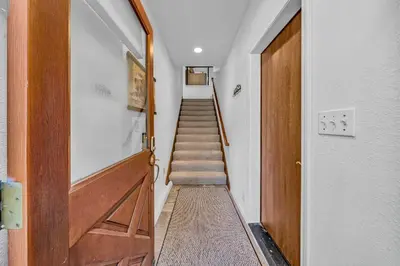 a hallway with a wooden door and a staircase at Tahoe Retreat with Decks and Separate Studio in Tahoe Vista