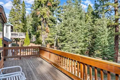 a wooden deck with a bench and trees at Tahoe Retreat with Decks and Separate Studio in Tahoe Vista