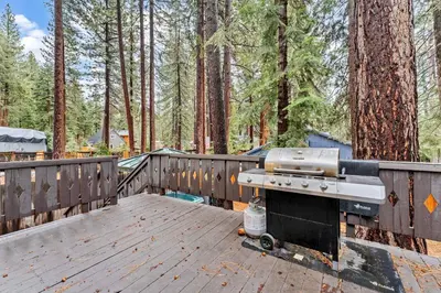 a grill sitting on top of a wooden deck at Kings Beach Cabin Private Hot Tub, Near Lake & Ski in Kings Beach