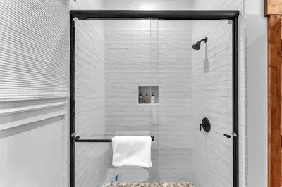 a bathroom with a shower with a glass door at Cozy Carnelian Bay Vacation Rental with Lake Views in Carnelian Bay